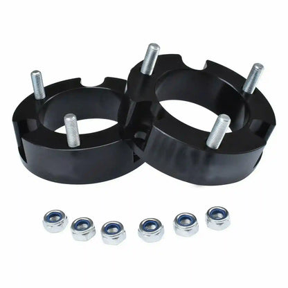 Two black Coil Strut Shock Spacers  with metal bolts and washers on a white background