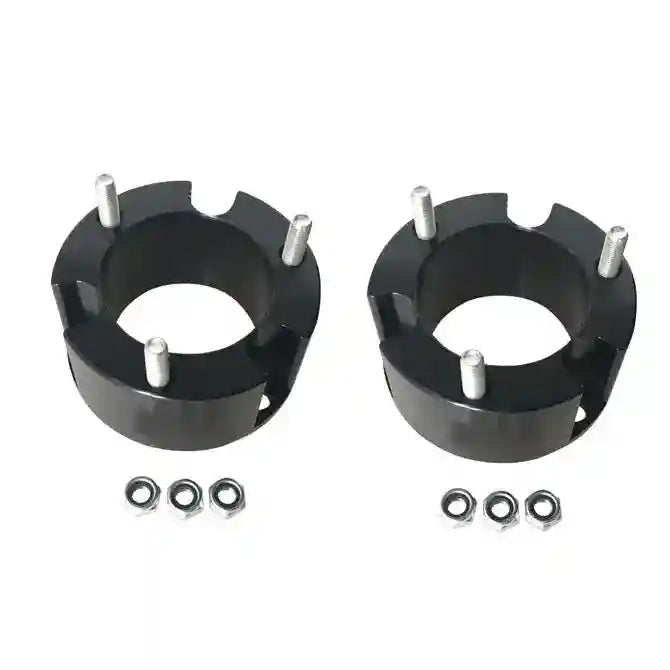 Two black metal Front Coil Strut Spacers with silver bolts and washers on a white background