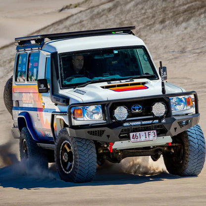 Toyota Land Cruiser on a dirt road with colorful design