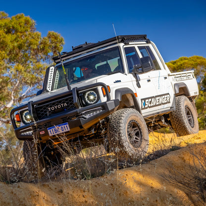 Toyota off-road vehicle on a rocky terrain with 'Scavenger' branding.