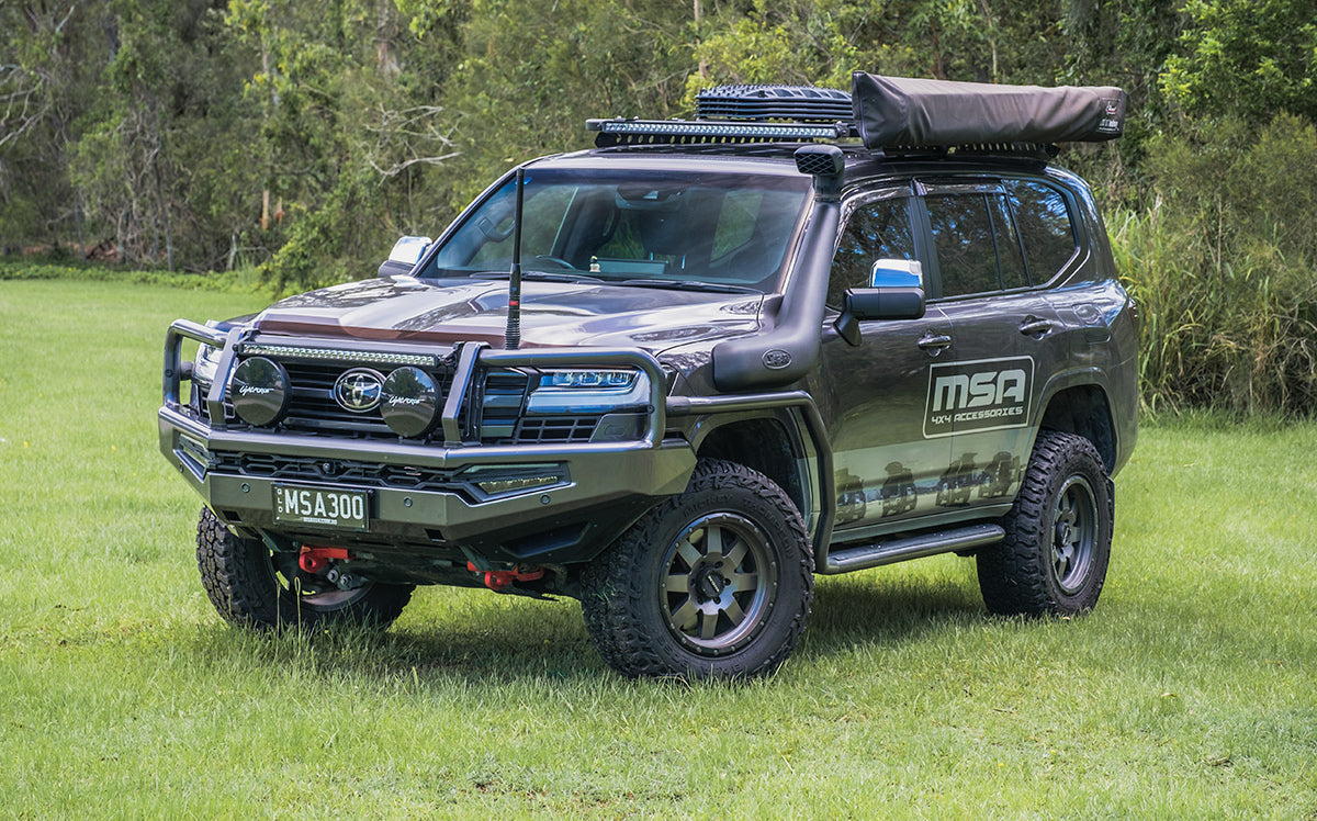 Toyota Land Cruiser SUV with roof rack and MSA branding on a grassy field
