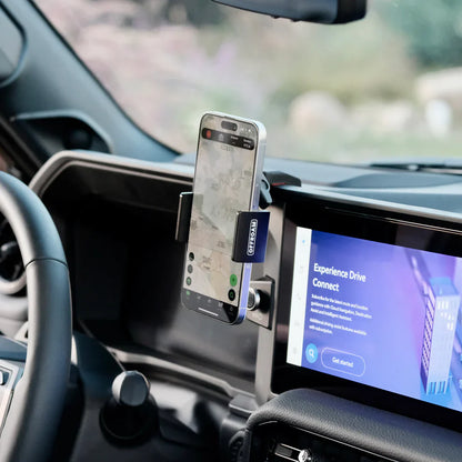 Phone mounted on a car dashboard with a navigation app displayed