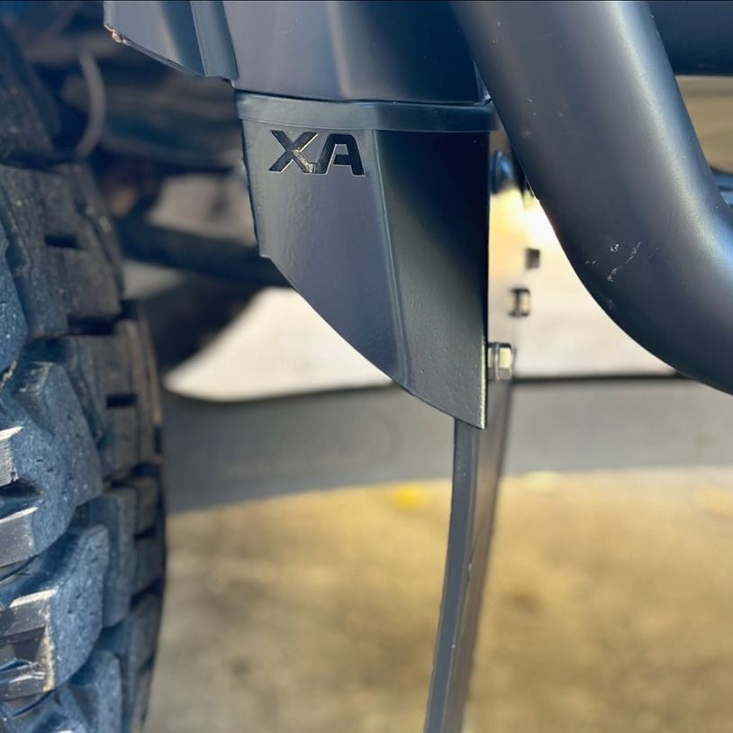 Close-up of a vehicle's Front Mudflaps with 'XA' branding on a blurred background