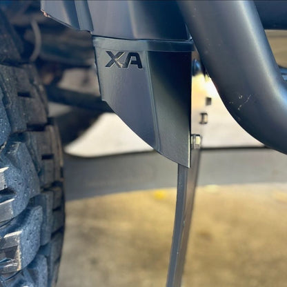 Close-up of a vehicle's Front Mudflaps with 'XA' branding on a blurred background