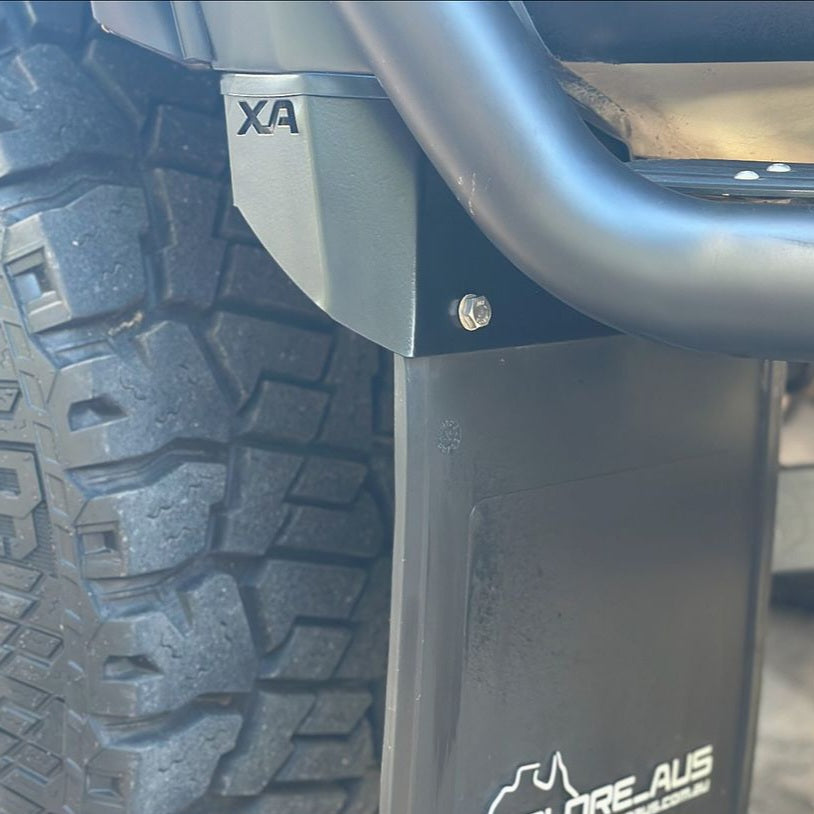 Close-up of a vehicle's tire and mud flap with 'XA' branding.