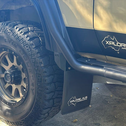 Close-up of a vehicle's tire and Front Mudflap with 'Xplor' branding.