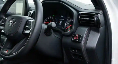 Interior view of Toyota LandCruiser 300 Series GR Sport dashboard showing Ultimate9 EVC Throttle Controller mounted near the steering column.