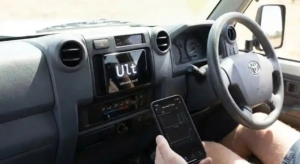Interior of Toyota LandCruiser 79 Series (2007 Model) showing Ultimate9 evcX Throttle Controller and Smartphone App.