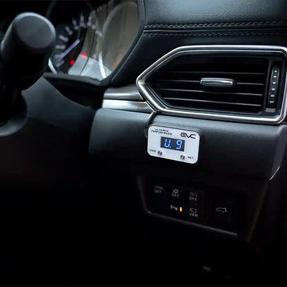 Car interior with a digital display showing '4.9' and 'EVC' on a black dashboard.