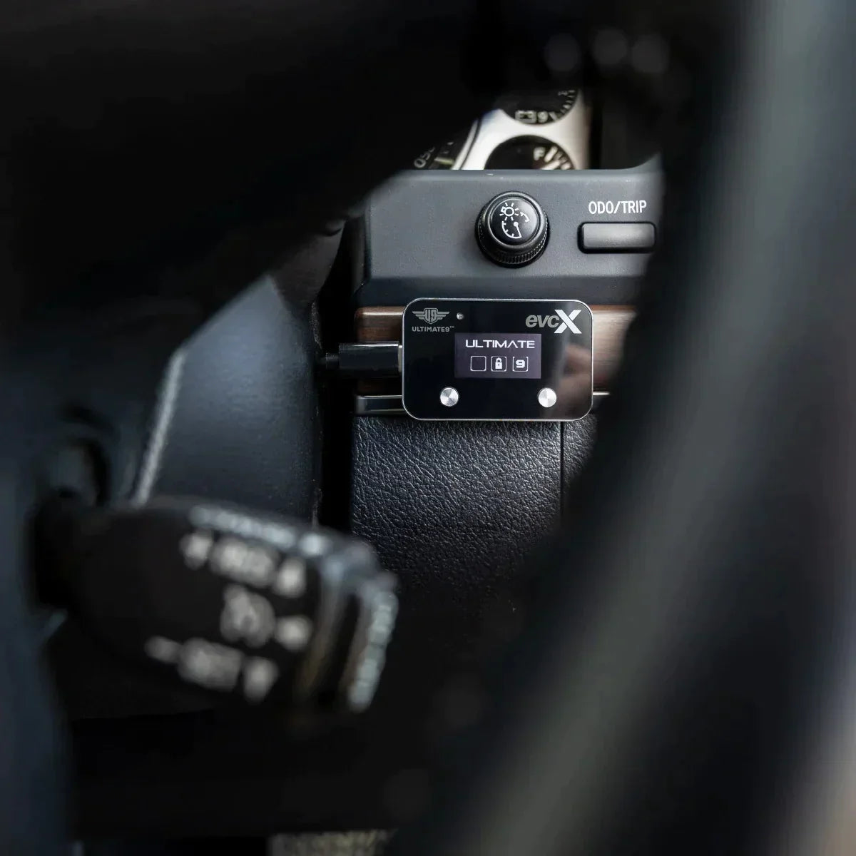 Close-up of a car's gear shift lever with Ultimate9 evcX Throttle Controller
