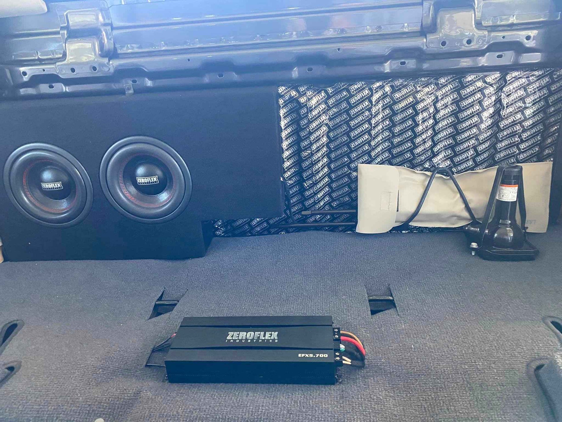 Car audio system with subwoofers and amplifier in a vehicle's cargo area.